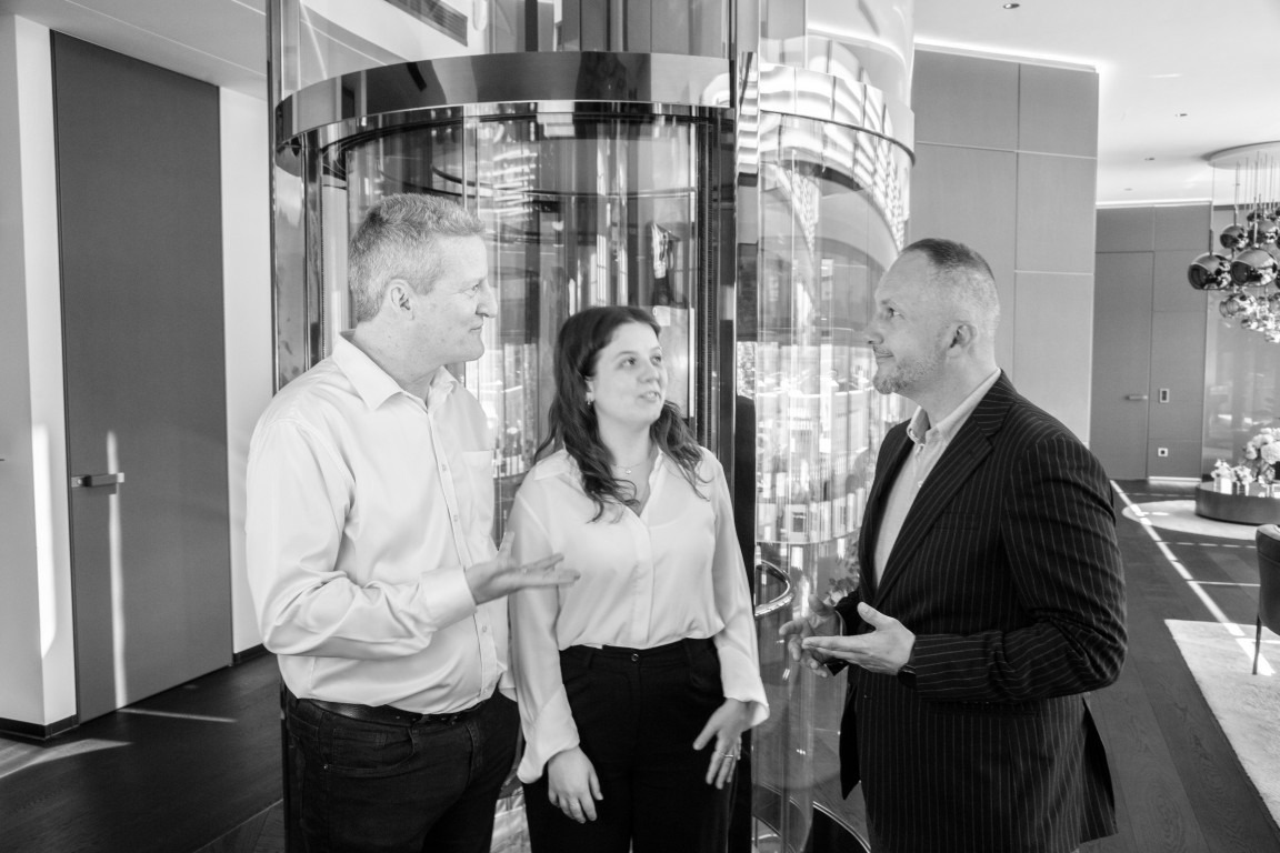 Experts from Kronos Advisory talk standing